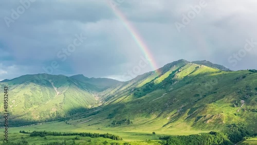 Aerial footage of green mountains and beautiful rainbow nature scenery in Xinjiang, China.