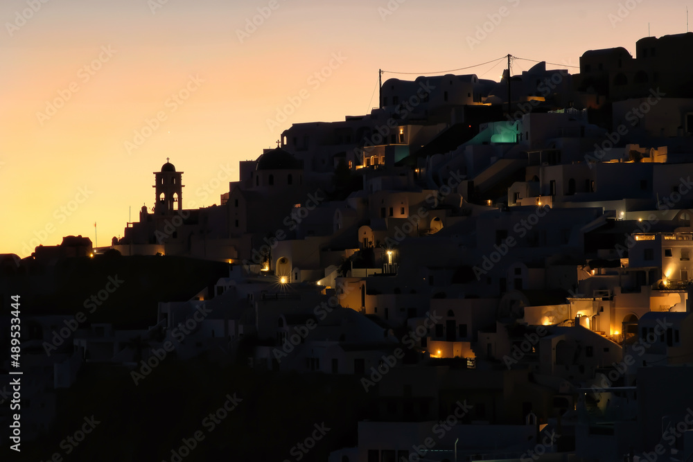 Panoramic view of the picturesque and illuminated village of Imerovigli and a colorful sunset