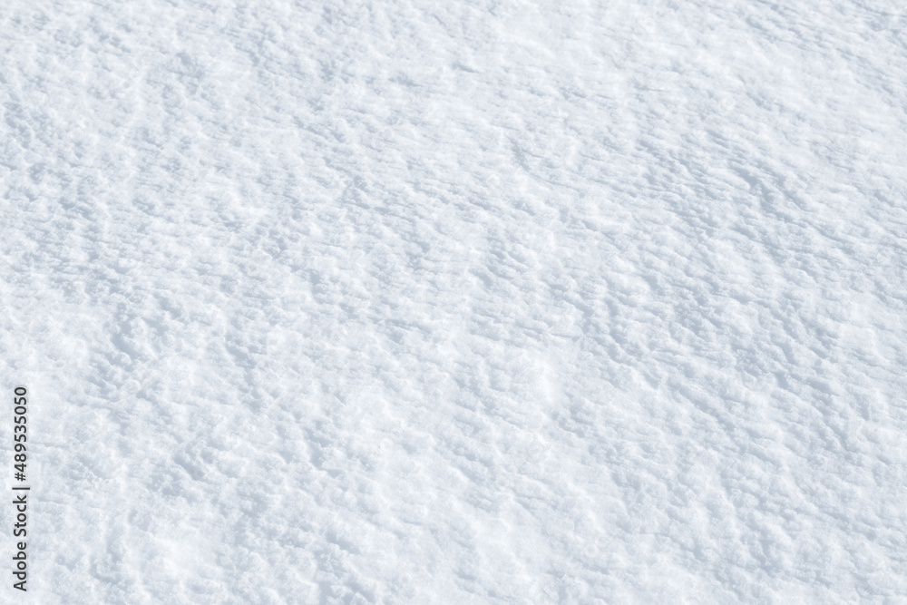 Fresh clean white snow background texture. Winter background with frozen snowflakes and snow mounds. Snow lumps. Seasonal landscape details. Cold weather.