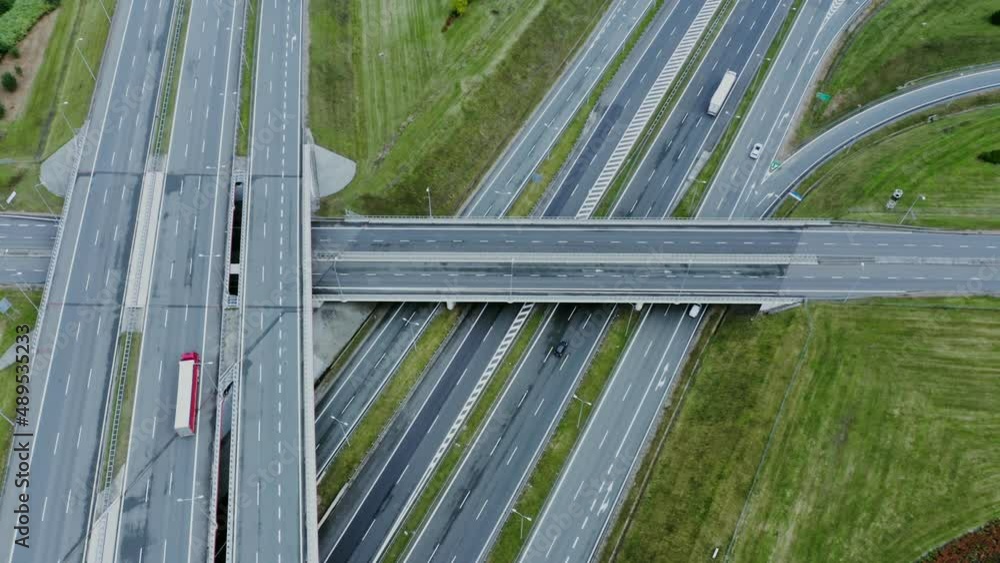 Video filming from a drone, view of the road junction with cars moving along it Video filming from a drone, view of the road junction with cars moving along it