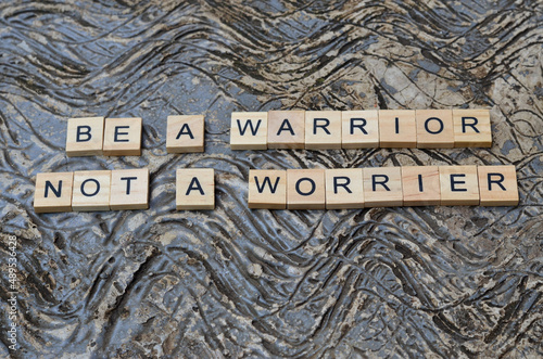 be a warrior not a worrier text on wooden square, business and motivation quotes