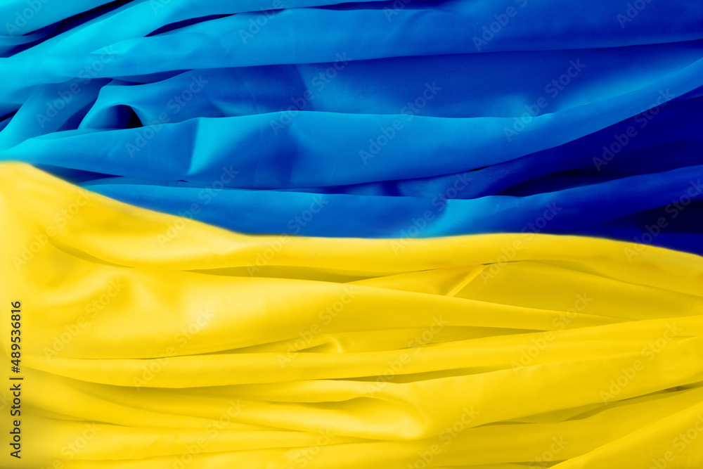 Abstract background of silk yellow blue flag of Ukraine
