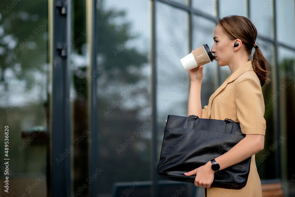 Caucasian woman with smartphone standing against street building background. Caucasian woman with smartphone standing against street building background.
