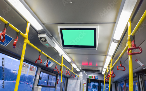 information board in the trolleybus cabin. selective focus. advertising in public transport. screen on the salon, a place for advertising. informing passengers while the trolleybus is on the route
