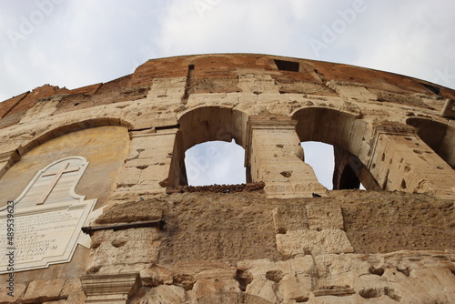 ROME, ITALY - February 05, 2022: Panoramic view of inside part of Colosseum in city of Rome, Italy. Cold and gray sky in the background. Macro photography of the arches.