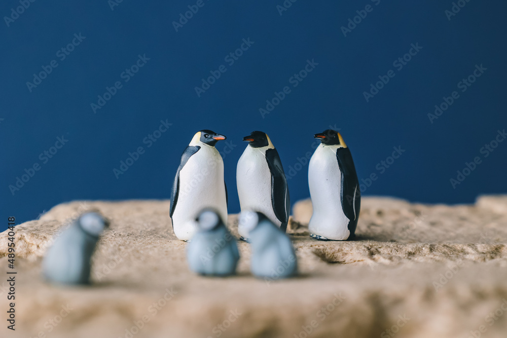 Obraz premium Cute miniature toy penguin colony. Wild animal family.