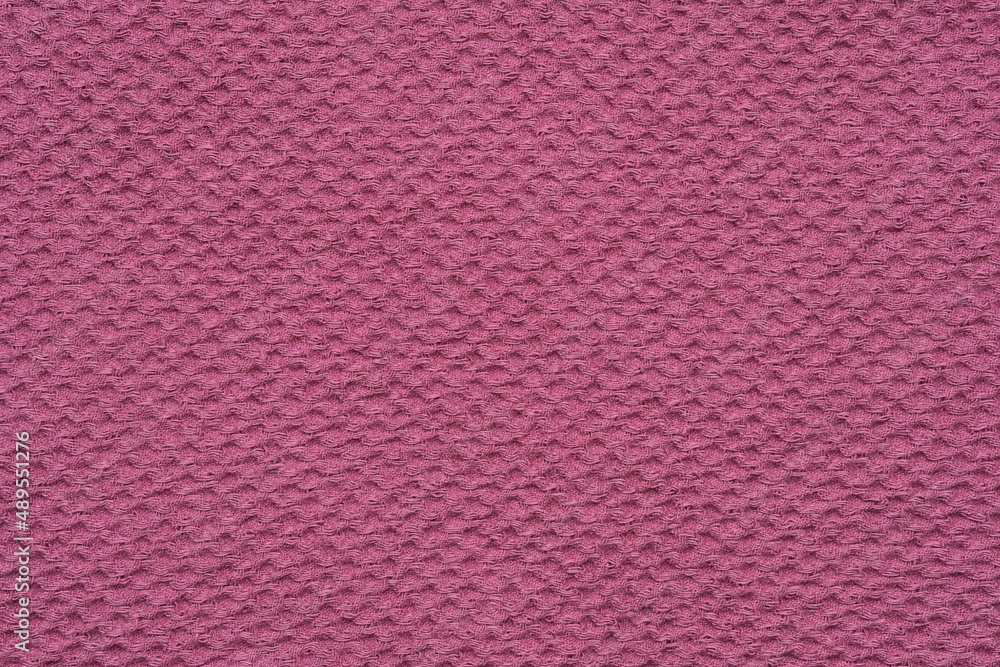 Texture of pink waffle towel. Background of natural waffled cloth from organic linen and cotton. Texture of pink waffle towel. Background of natural waffled cloth from organic linen and cotton.