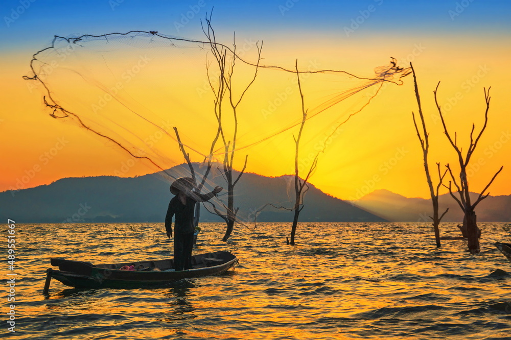 Fishermen fishing in the early morning golden light.