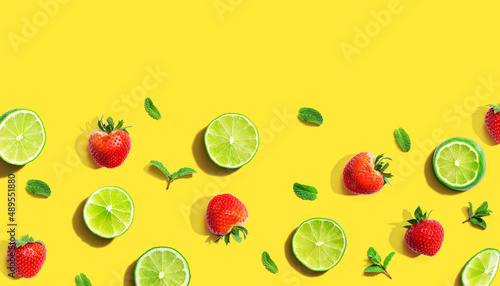 Fototapeta Naklejka Na Ścianę i Meble -  Fresh limes and strawberries with mints - flat lay