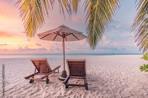 Closeup sea sand beach. Couple beach landscape. Inspire romantic tropical seascape horizon. Orange gold sunset sky calmness tranquil relaxing summer mood. Chairs, umbrella for vacation travel holiday 