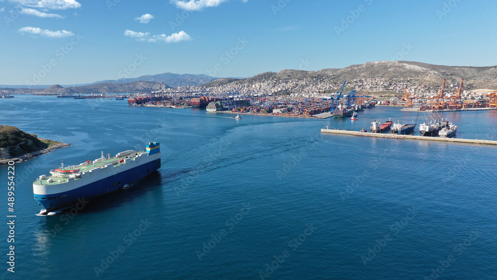 Aerial drone photo of Ro Ro (Roll on Roll off) automobile carrier vessel leaving international car terminal in Keratsini area, Piraeus, Attica, Greece