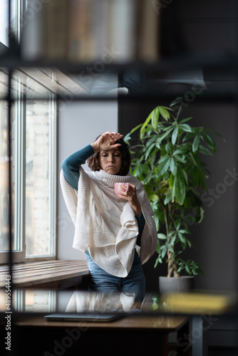 Fotografie Unhealthy businesswoman touching forehead, feeling unwell sick at workplace, fem
