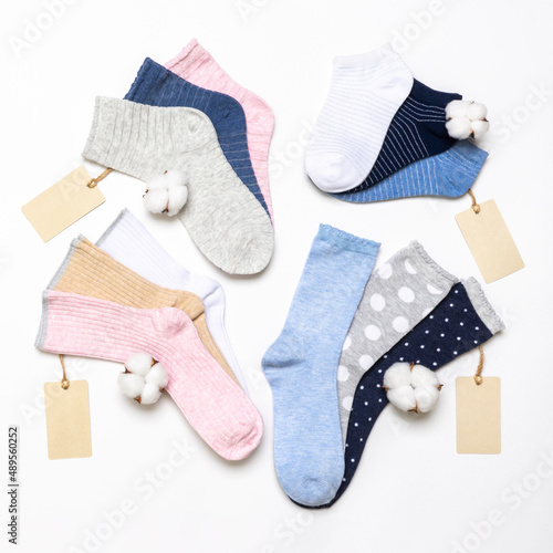 Various modern trendy women's cotton socks set with cotton flowers and price tags on white background. Fashionable socks store. Socks shopping, sale, merchandise, advertisement concept