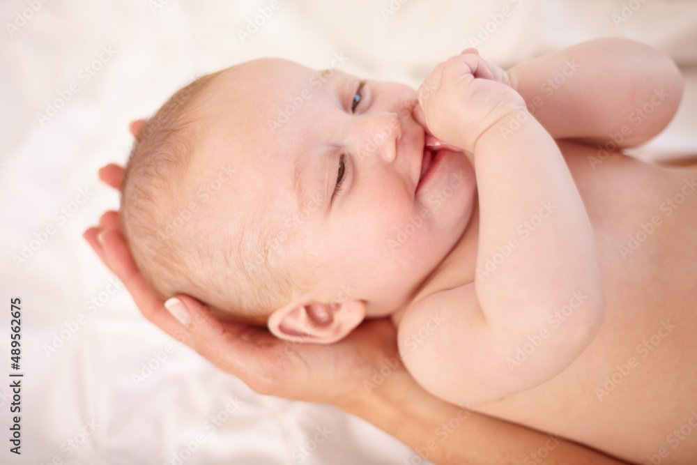 Mothers hold the future in their hands. Happy little baby lying in its mothers hands. Mothers hold the future in their hands. Happy little baby lying in its mothers hands.