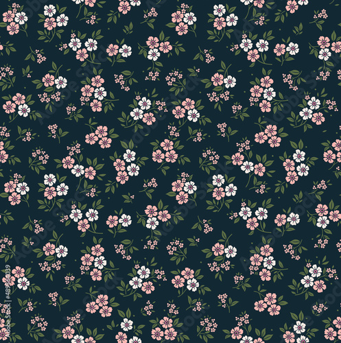 Trendy seamless vector floral pattern. Endless print made of small white and pink flowers. Summer and spring motifs. Dark blue background. Stock vector illustration.