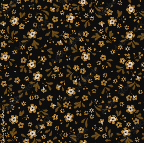 Floral background in vintage style. Decorative embroidery flowers. Vector seamless pattern. Ornament for textiles on black background. Small gold flowers. The elegant the template for fashion prints