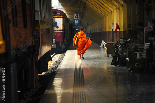 A commuter monk walks towards the exit gate upon his arrival at Hau Lumpong Station in Bangkok. 