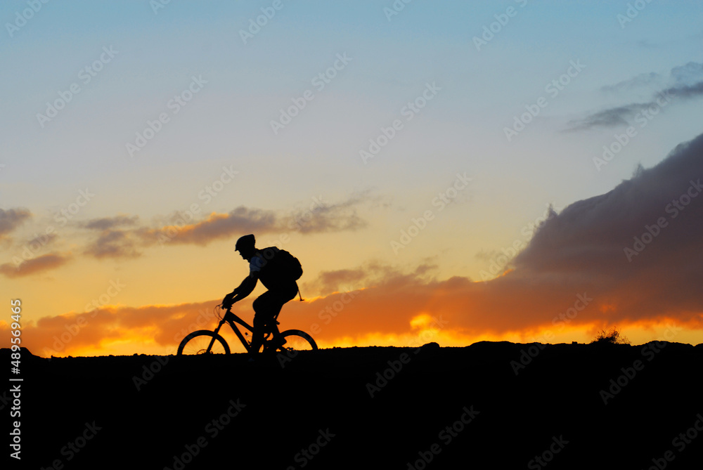 mountain rider biker on sunset  landscape