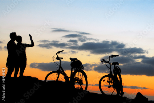 couple do selfie on the sunset with bikes landscape