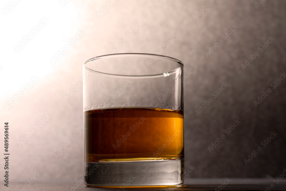 glass goblet with whiskey on a dark background glass goblet with whiskey on a dark background