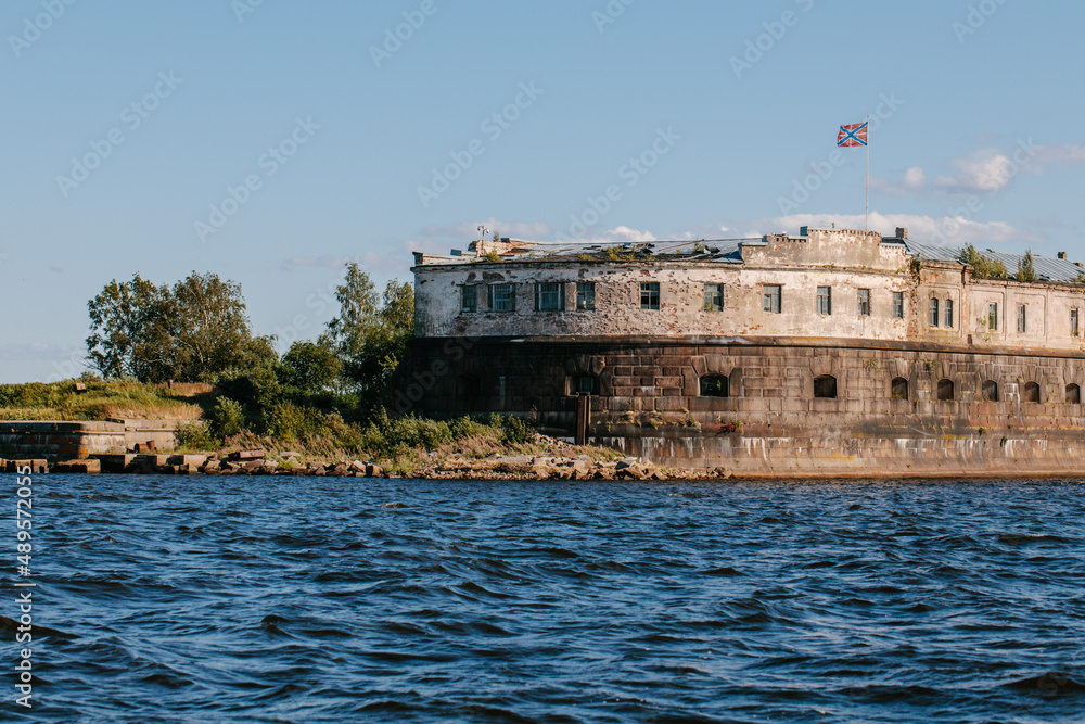 View from the water of the oldest fort Kronshlot and the lower sash lighthouse in the waters of the Gulf of Finland in Kronstadt,crown castle,defensive fortress