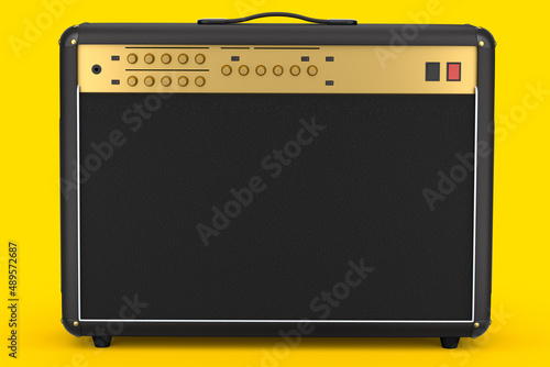 Classical electric and acoustic guitar amplifier isolated on yellow background. photo