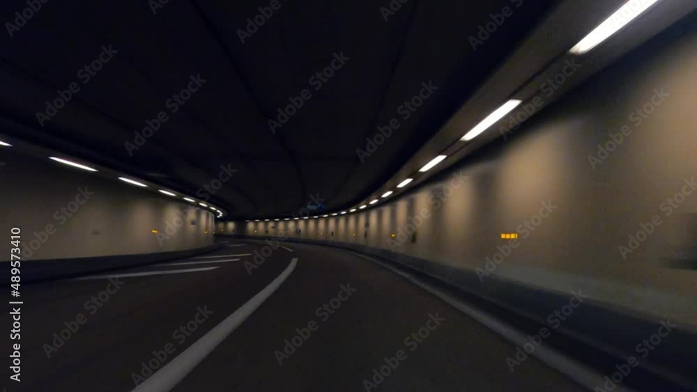 Point of view car driving in an empty tunnel