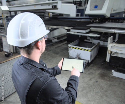 Engineer In Factory Using Digital Tablet