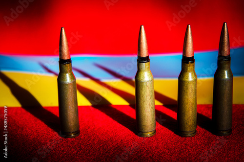 Obraz na płótnie Abstract image of military bullets on the background of the Ukrainian flag and blood color (War in Ukraine - concept) w salonie