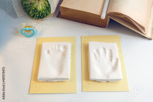 Baby footprint and handprint clay mold To remember in the future how small the baby was in childhood photo