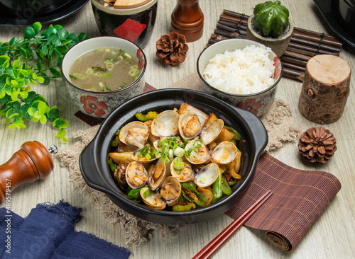 Fragrant pot sixtie seashell with rice and soup isolated on mate top view of chinese food table