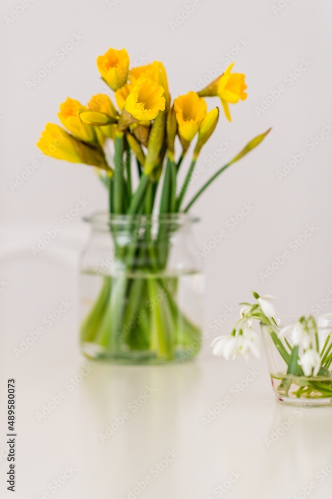 Freshly picked daffodils, on a table in a glass vase. Symbol of spring. Freshly picked daffodils, on a table in a glass vase. Symbol of spring.