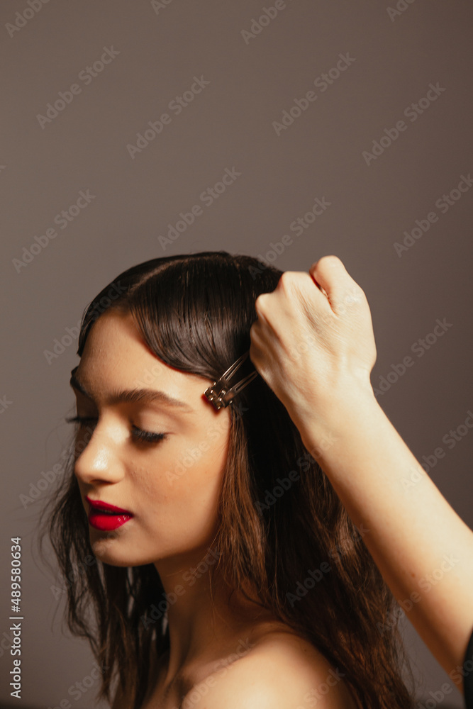 Fototapeta premium Portraits of a beautiful girl with makeup and red lips