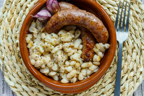 butifarra with beans, Botifarra amb mongetes or Botifarra amb seques, is a traditional dish of Catalan cuisine, based on butifarra and white beans. photo