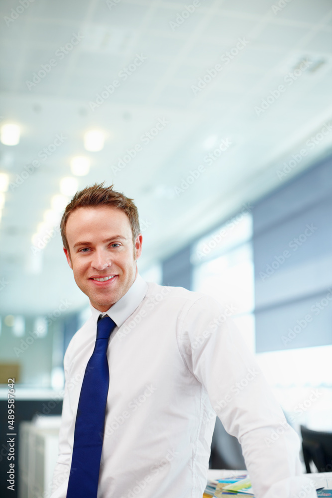 Positive hell be successful. Handsome young male executive in his workplace. Positive hell be successful. Handsome young male executive in his workplace.