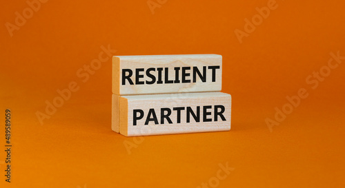 Resilient partner symbol. Concept words Resilient partner on wooden blocks on a beautiful orange table orange background. Business resilience and resilient partner concept, copy space.