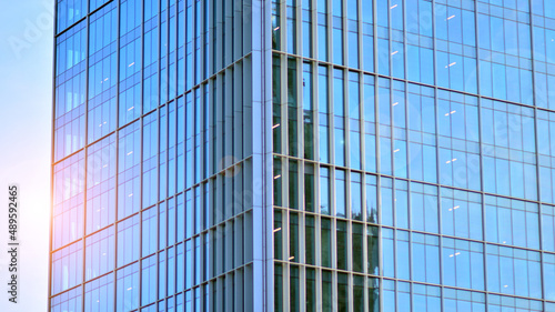 Urban abstract - windowed wall of office building. Detail shot of modern business building in city. Looking up at the glass facade of a skyscraper.