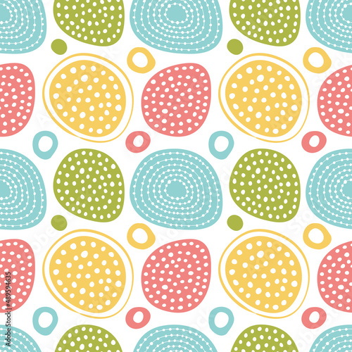 Seamless background with abstract ornament with colored circles and hearts.