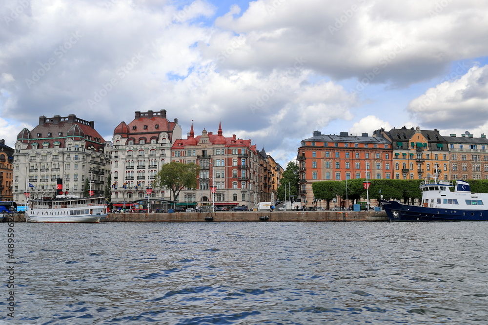 Naklejka premium Sweden, Stockholm’s architecture, Scenic river views of Stockholm Skyline. Riddarholm Church, Famous Popular Destination Scenic Place In Dusk Lights.