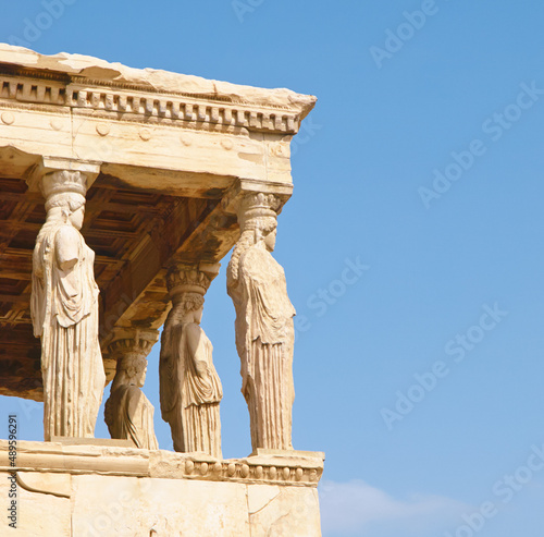 OLYMPUS DIGITAL CAMERA. A series of pillars carved into the shapes of a women in Acropolis, Greece.