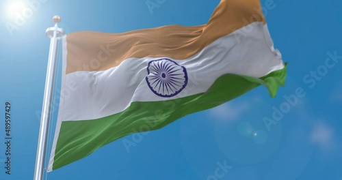 View of Indian flag flapping on flagpole with sky behind