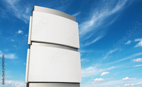 Blank company sign stele mockup  outdoors against cloudy sky 