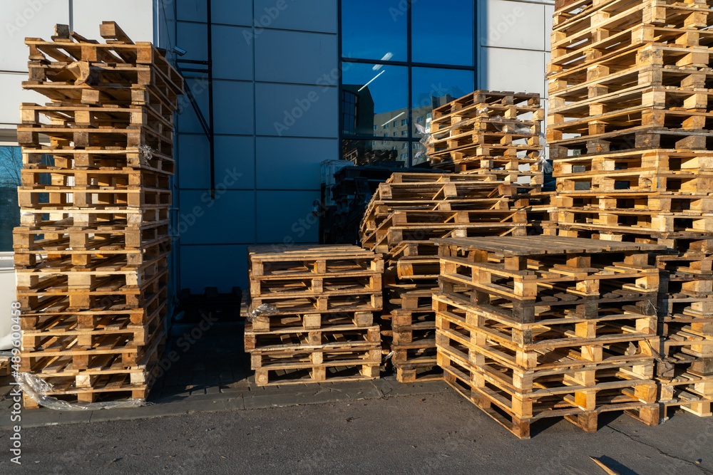 Stacked wooden pallets at a storage or near a shop