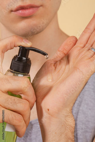Wallpaper Mural Young and happy man taking care of his skin. Skin care routine. Beautiful model and spa. Isolated beige background. Torontodigital.ca
