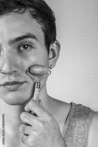 Wallpaper Mural Young and happy man taking care of his skin. Skin care routine. Beautiful model and spa. Isolated beige background. Torontodigital.ca