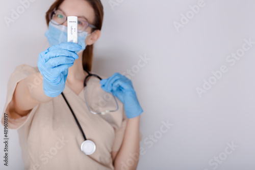 Wallpaper Mural Woman doctor or medtech shows rapid laboratory COVID-19 test. Rapid test kit on white background and copy space, Coronavirus infectious protect concept Torontodigital.ca