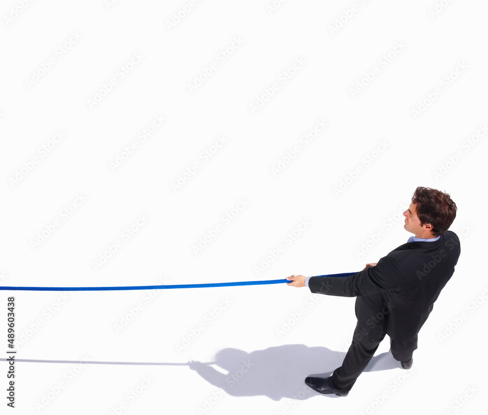 Top view of an isolated business man pulling on to a rope. Tug of war - Top view of a young business man pulling on to a rope. Top view of an isolated business man pulling on to a rope. Tug of war - Top view of a young business man pulling on to a rope.