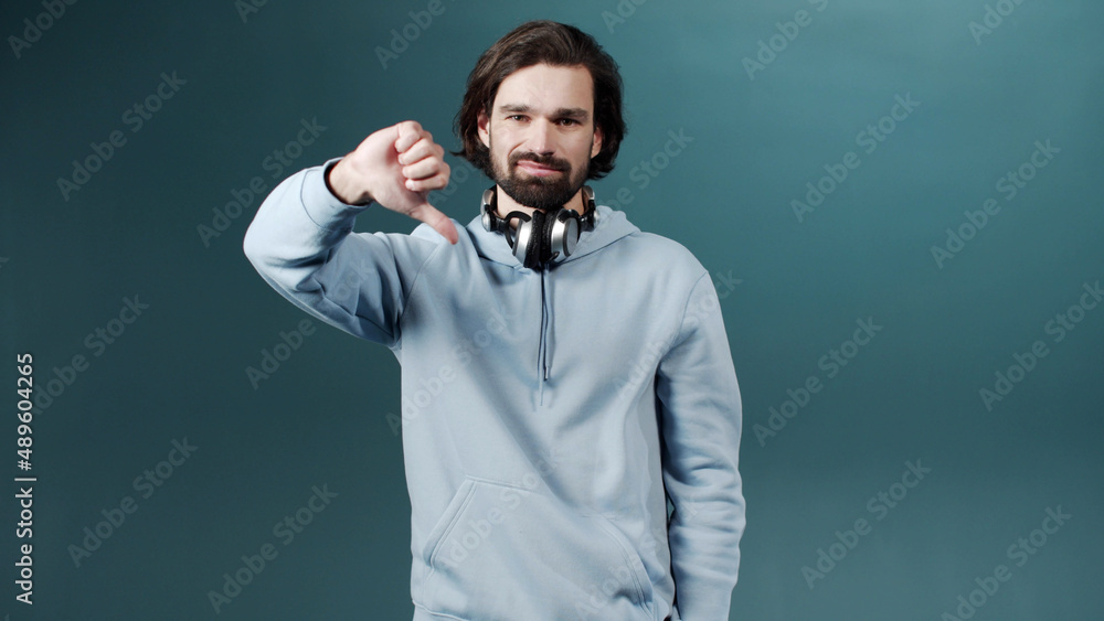 Fototapeta premium A young beautiful man is gesturing and looking at the camera