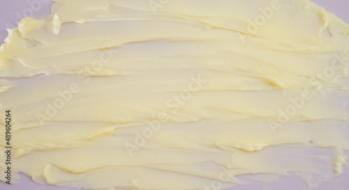Obraz na płótnie Cosmetic products creamy yellow stain texture on pink background. Texture of natural cosmetics, hair mask, cream, scrub w salonie