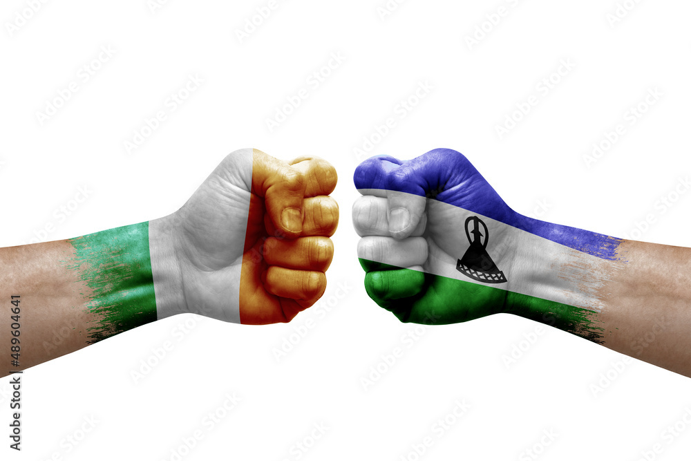 Two hands punch to each others on white background. Country flags painted fists, conflict crisis concept between ireland and lesotho Two hands punch to each others on white background. Country flags painted fists, conflict crisis concept between ireland and lesotho
